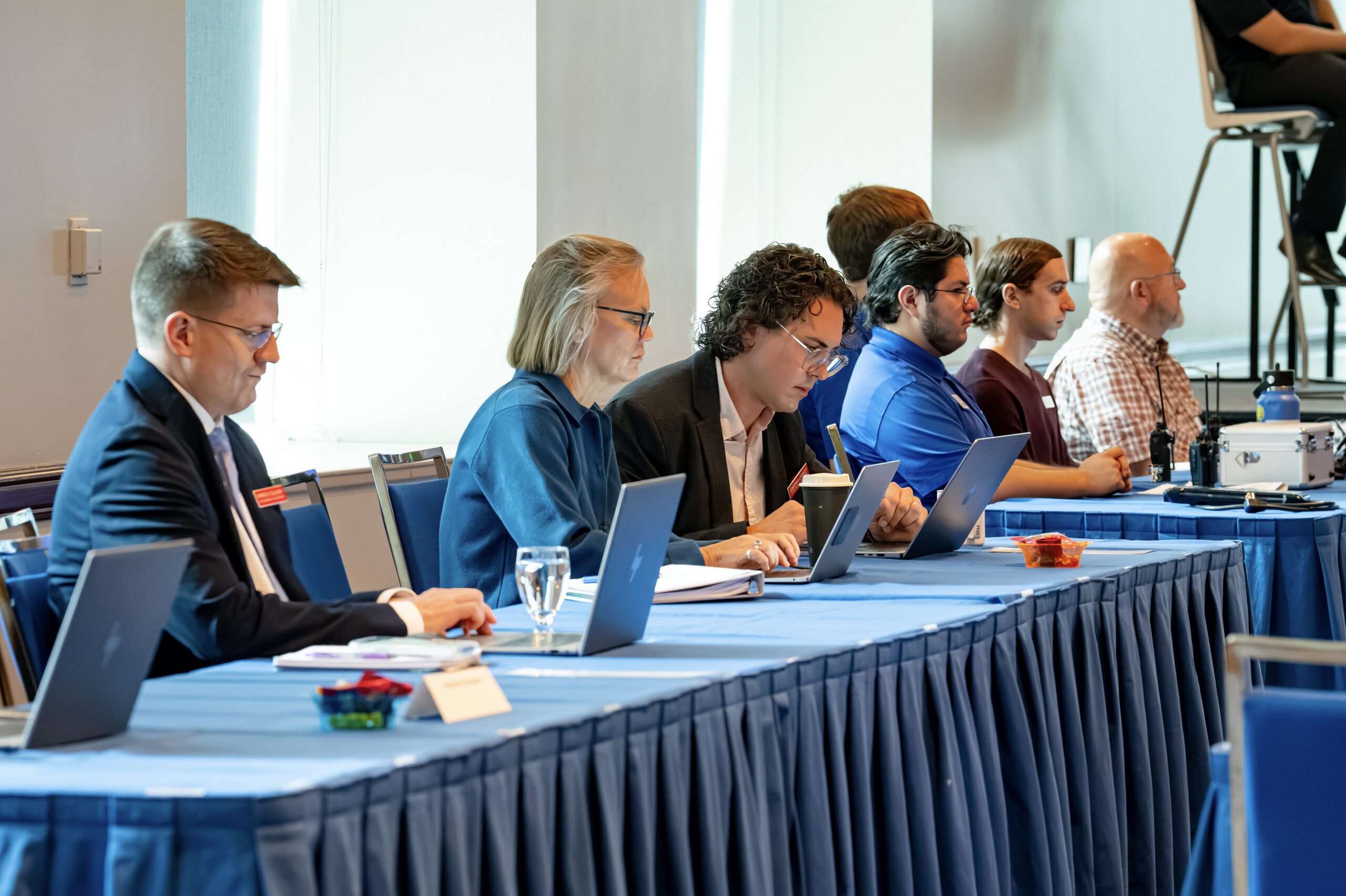 Board staff working during a board meeting