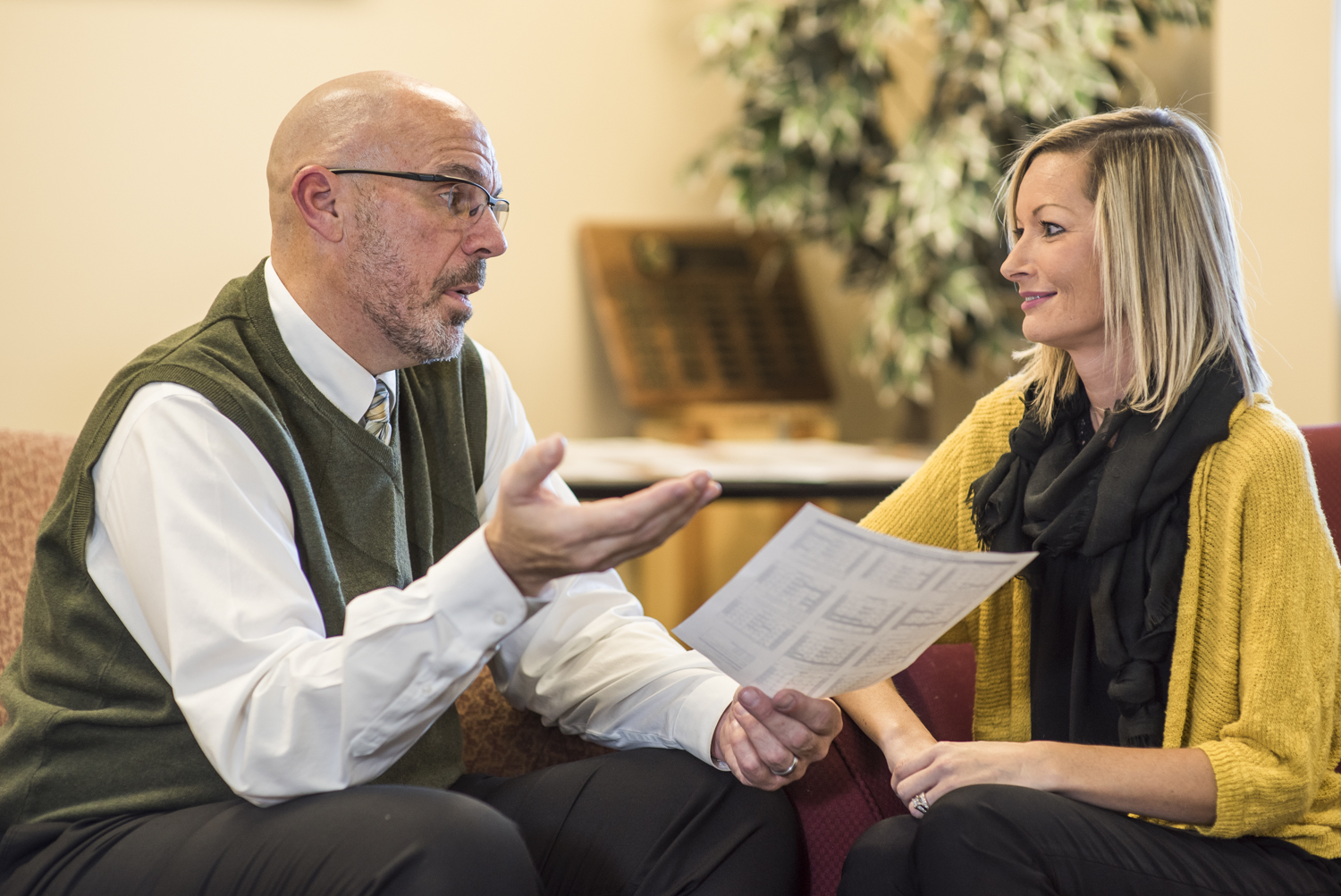 Administrator discussing document with teacher