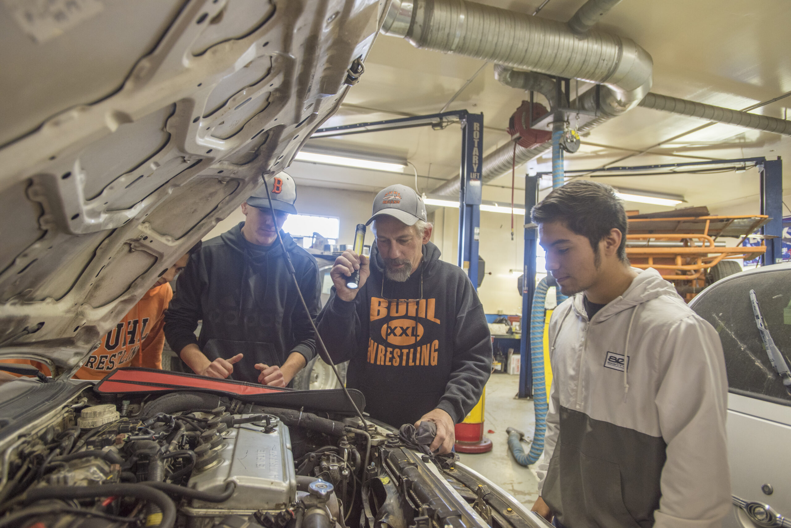 two students learning about automotive repair
