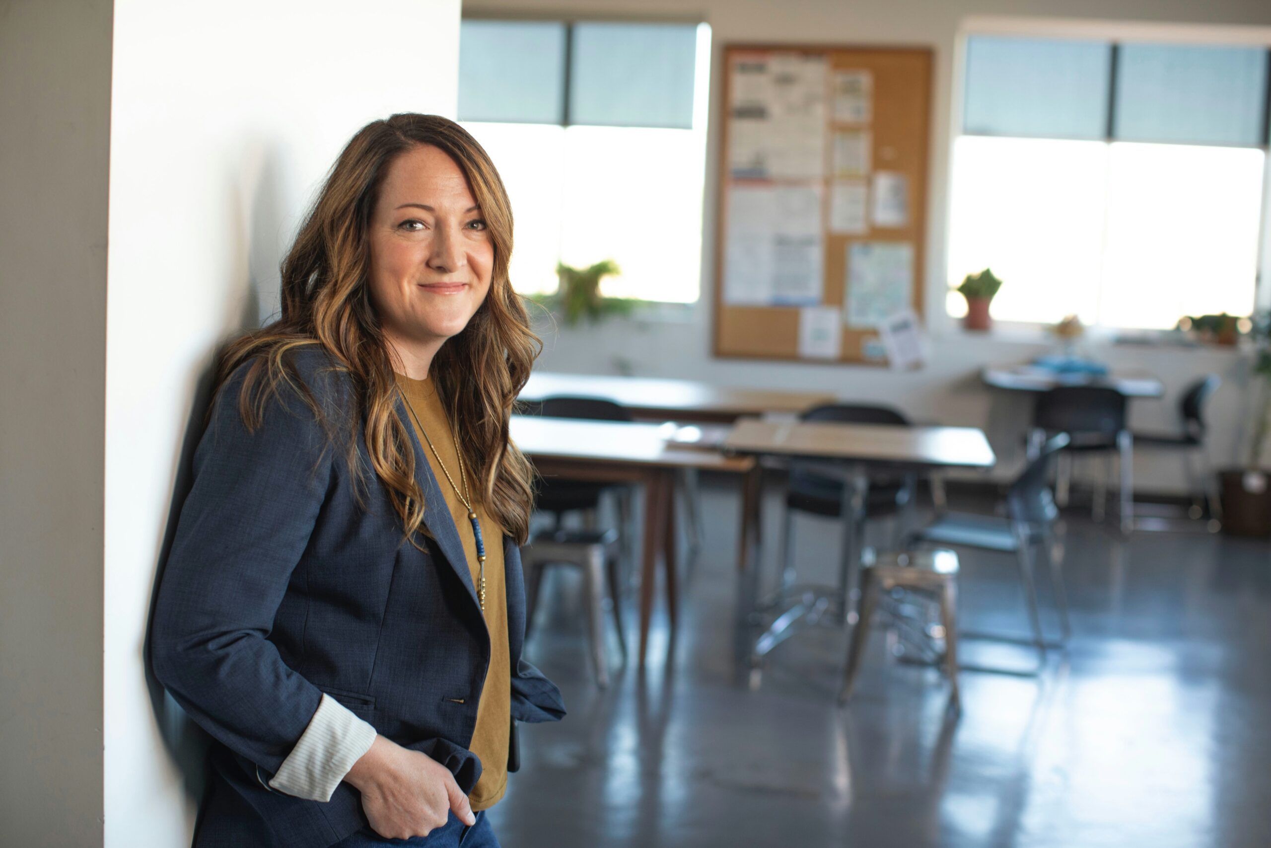 principal standing in an empty classroom