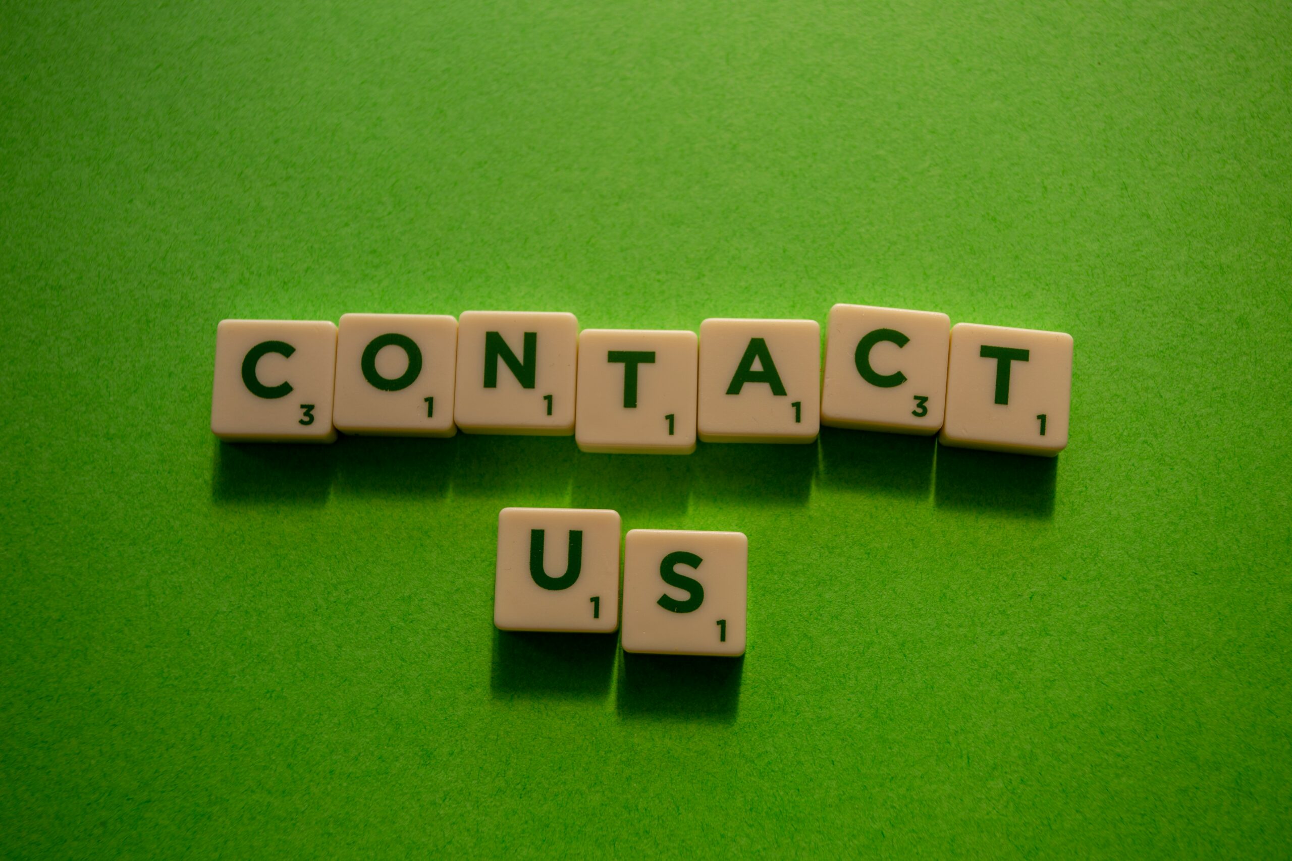 scrabble pieces that say contact us