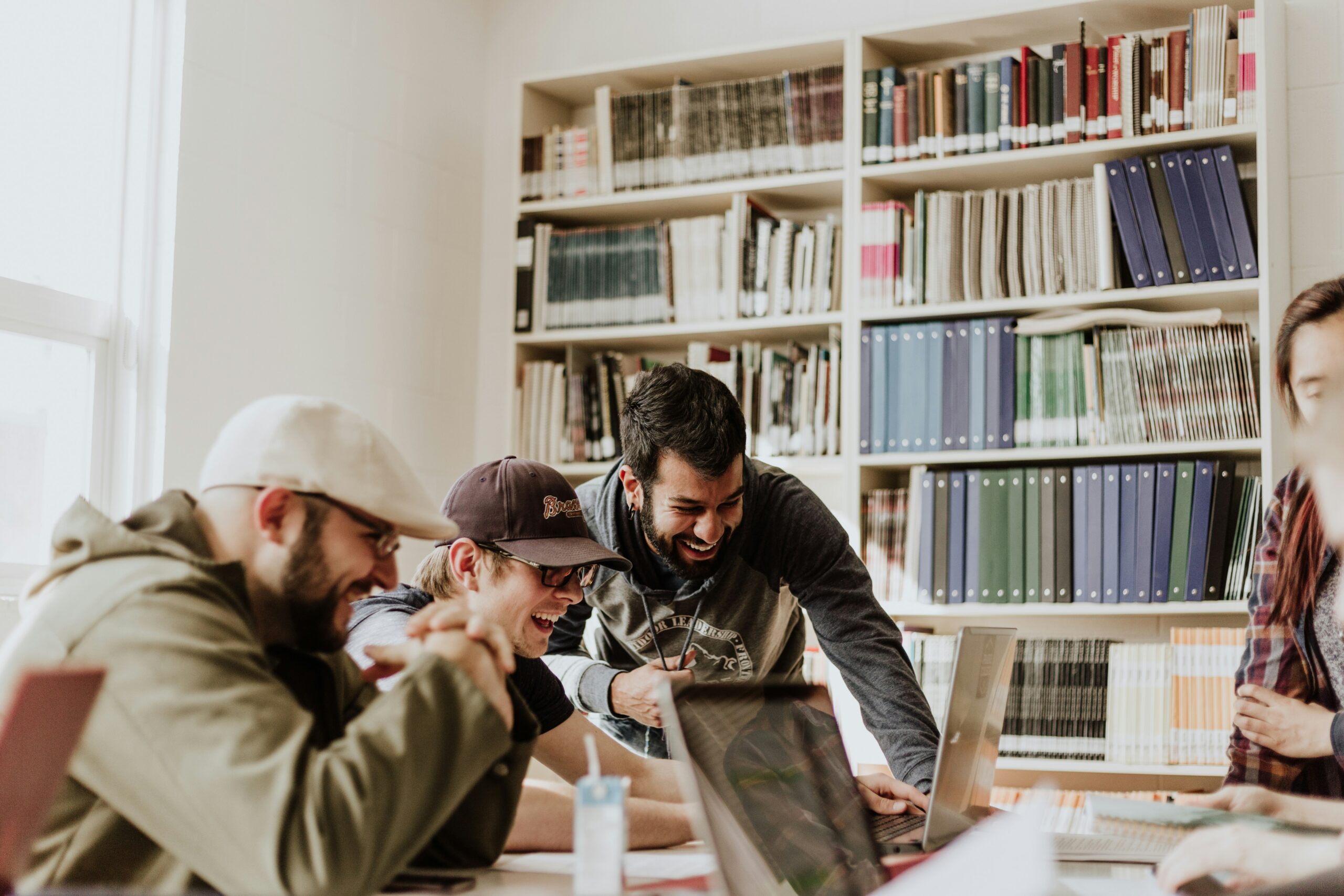 college students working around a table in the library