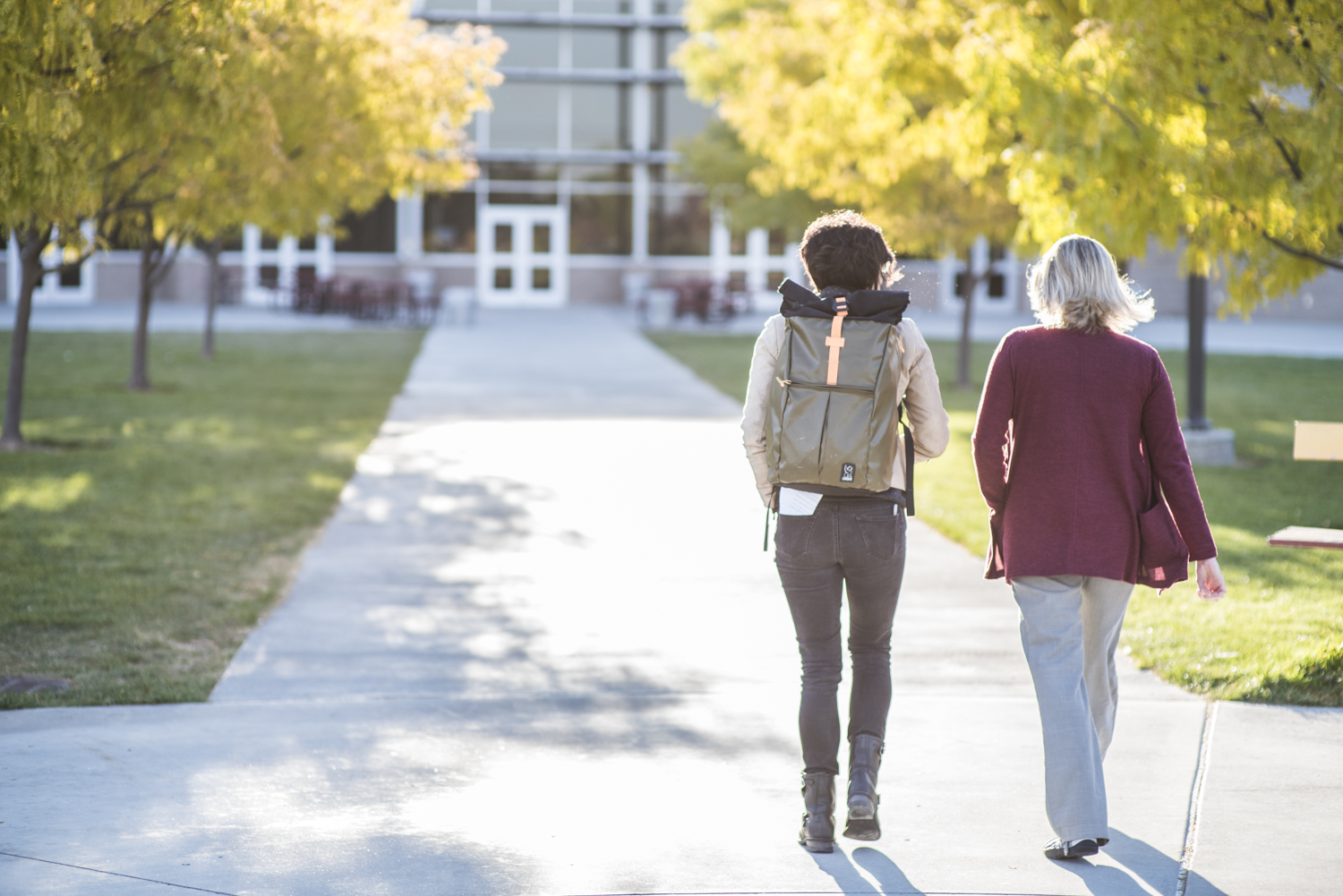 two people walking toward a school